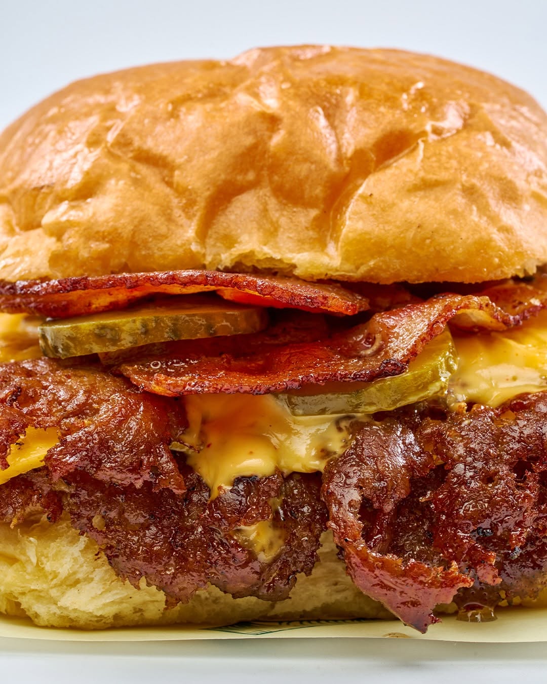Smash burger close-up with bacon and cheddar